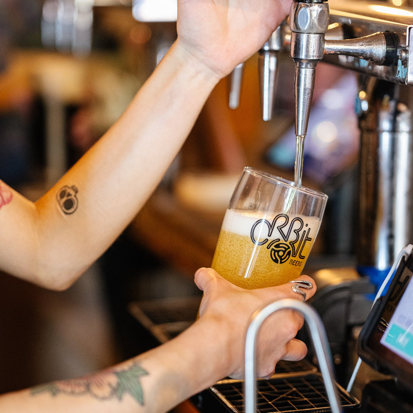 Amber beer poured into an Orbit Beers glass at the taproom, a Brewser craft beer subscription partner