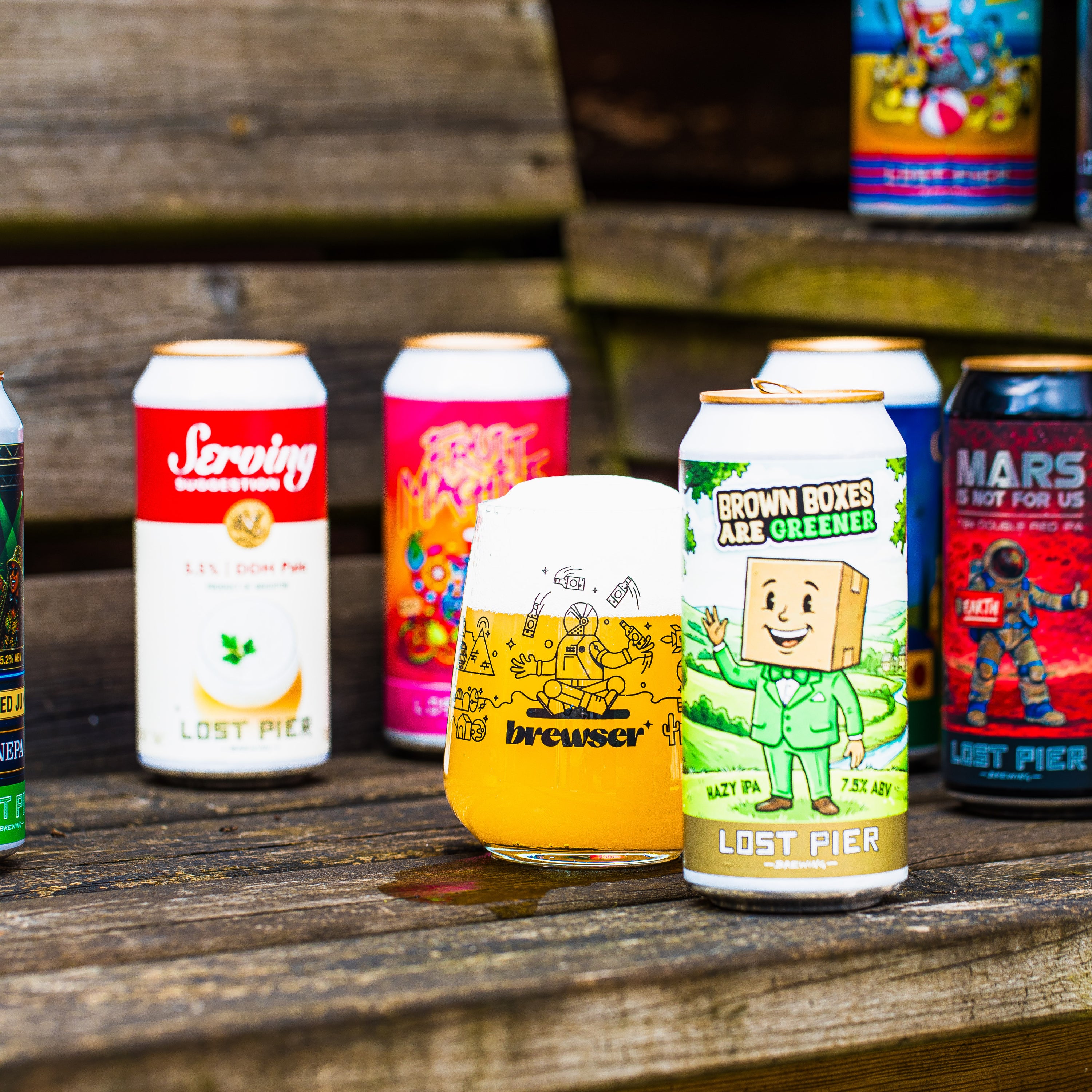 Lost Pier Brewing mixed can selection including Brown Boxes Are Greener Hazy IPA with Brewser glass, craft beer subscription
