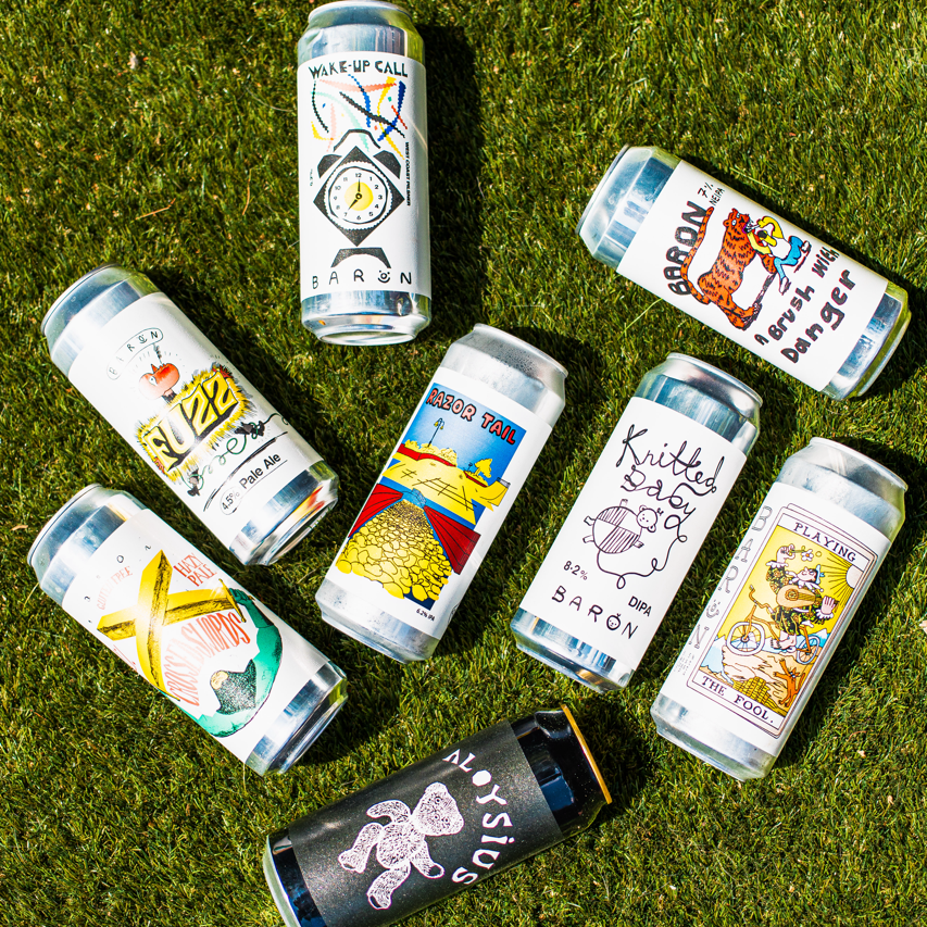 Baron Brewing can lineup on grass including Razor Tail, Knitted Dog and Wake-Up Call, Brewser subscription box