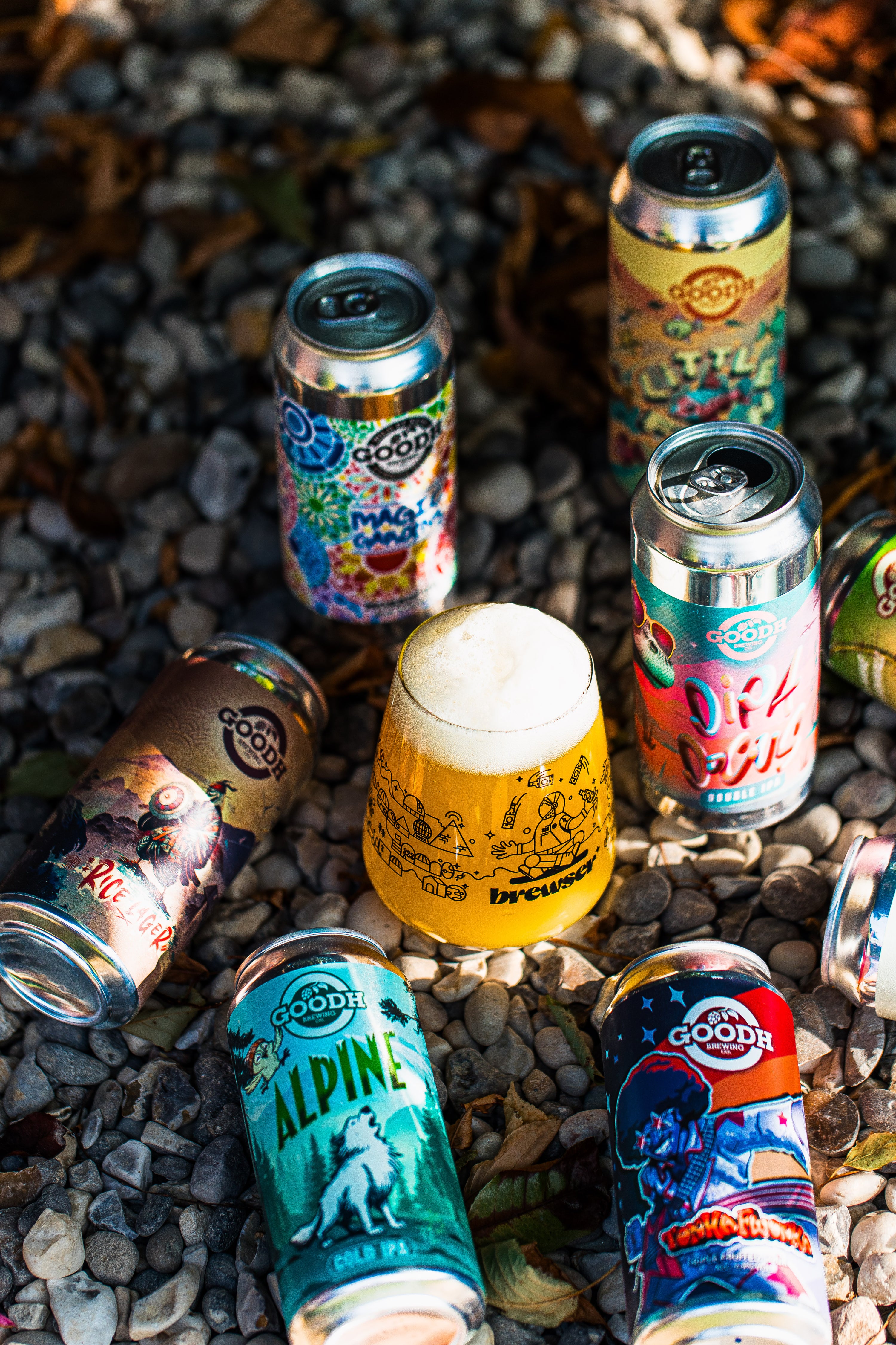 GOODH Brewing cans and a poured Brewser glass on pebbles, craft beer subscription lifestyle