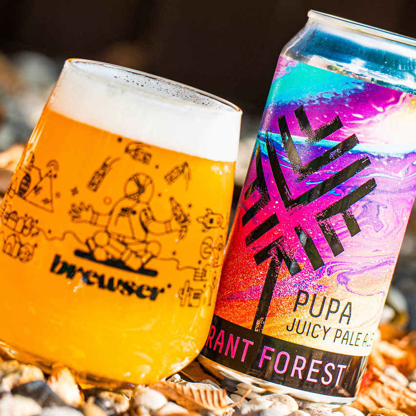 Vibrant Forest Pupa Juicy Pale Ale can beside a poured Brewser glass, craft beer subscription lifestyle