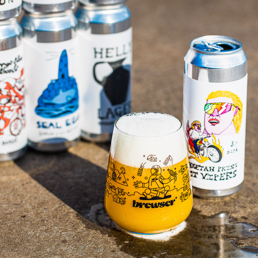 Brewser branded beer glass with frothy pale ale alongside Baron Brewing Seal Lager and Cheetah From Mt Vipers craft beer cans - Brewser craft beer subscription direct from brewery