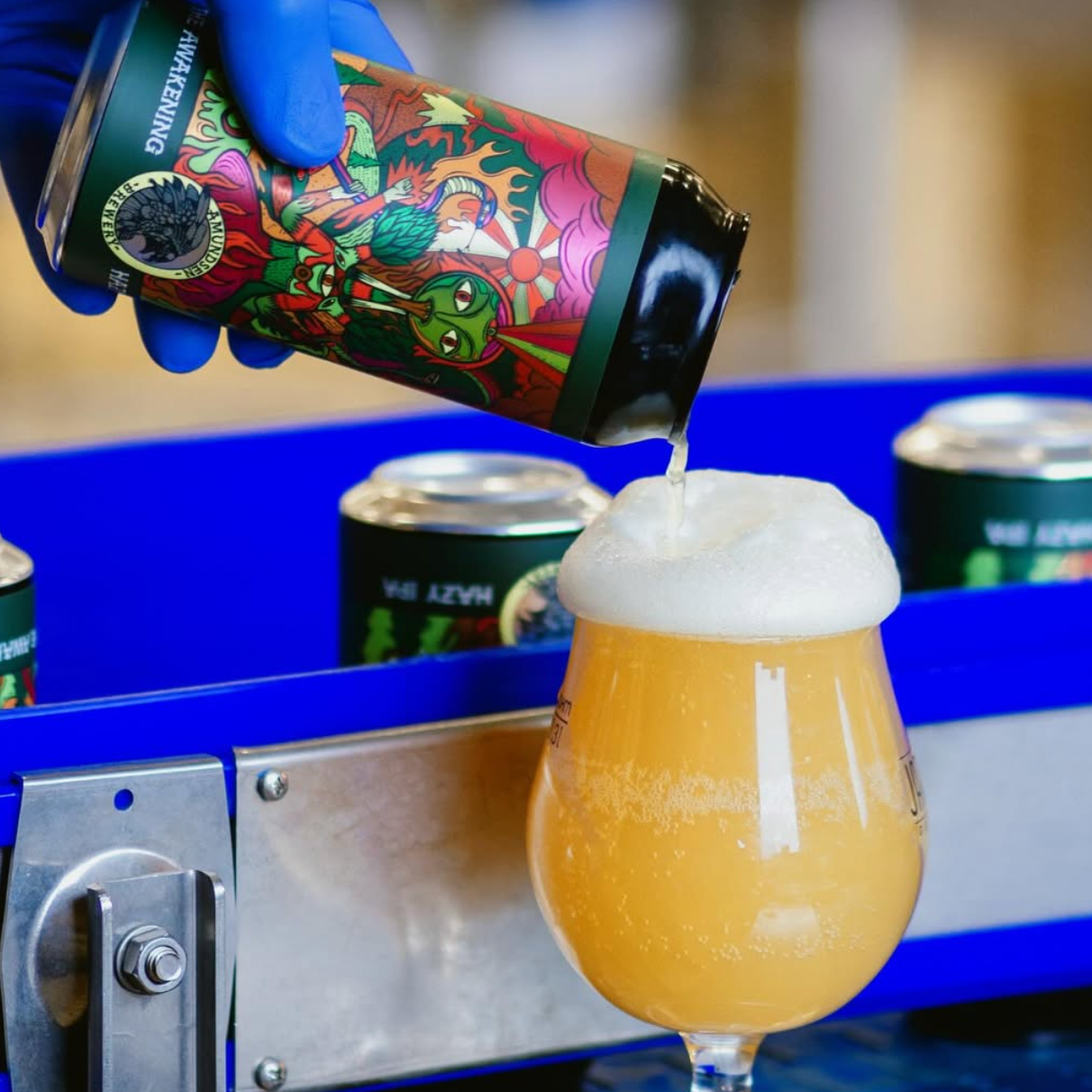 Awakening Hazy IPA poured from a colourful can into a stemmed glass, Brewser craft beer subscription pour