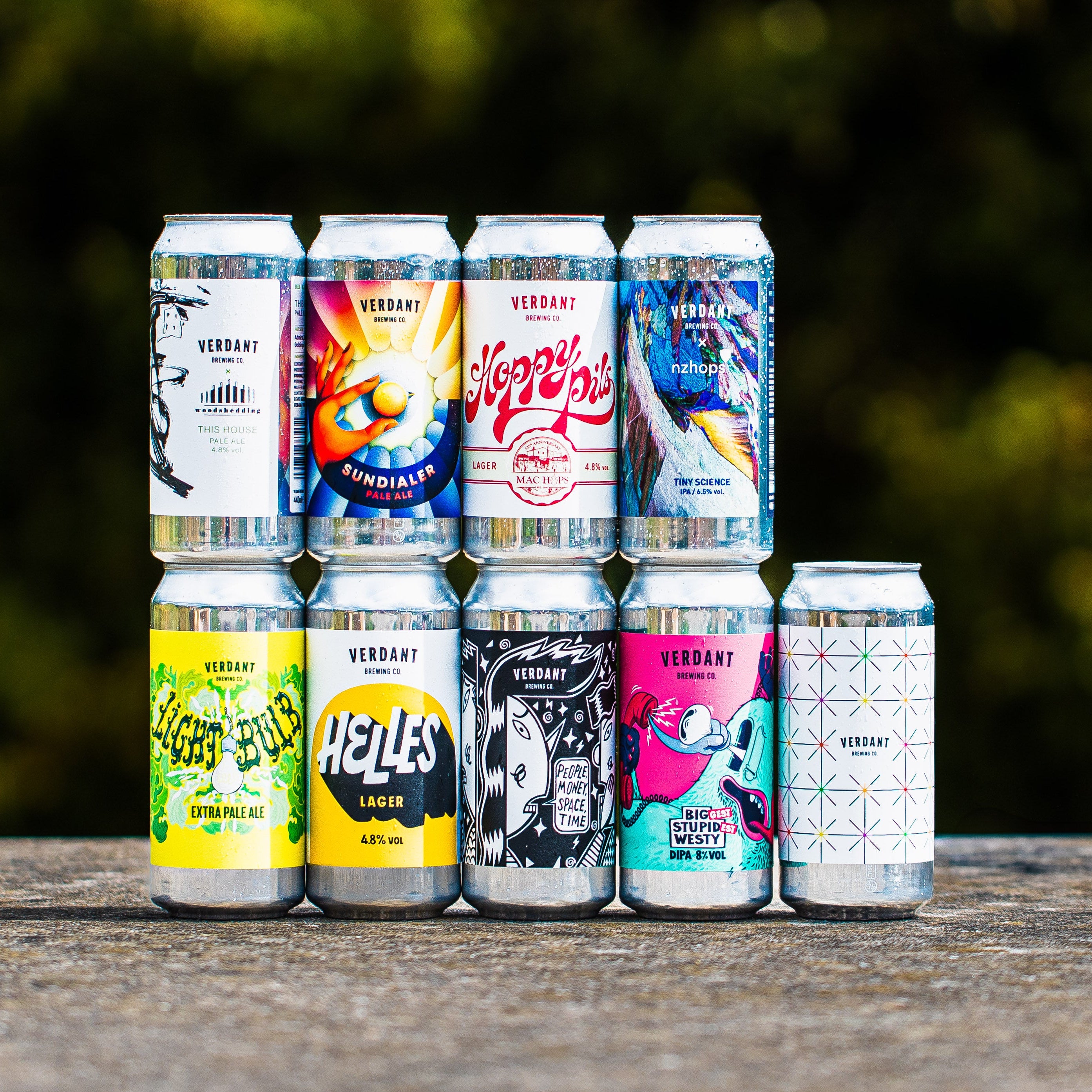 Verdant Brewing Co craft beer can range including Sundialer, Hoppy Pils, Light Bulb Extra Pale Ale, Helles Lager and Big Stupid Westy DIPA arranged on wooden surface - Brewser craft beer subscription box direct from brewery UK