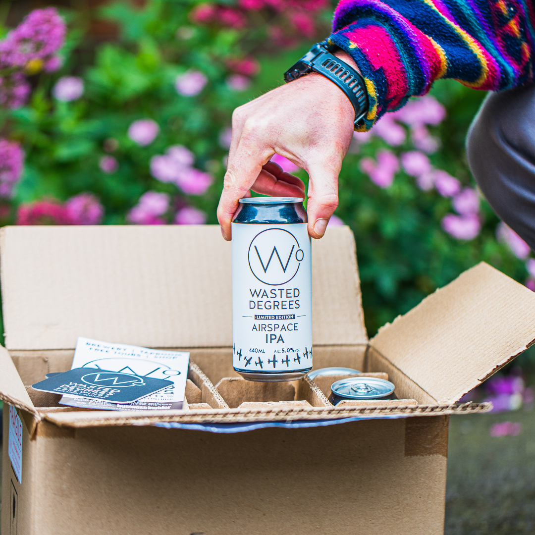 Wasted Degrees Airspace IPA being lifted from an open Brewser craft beer subscription box