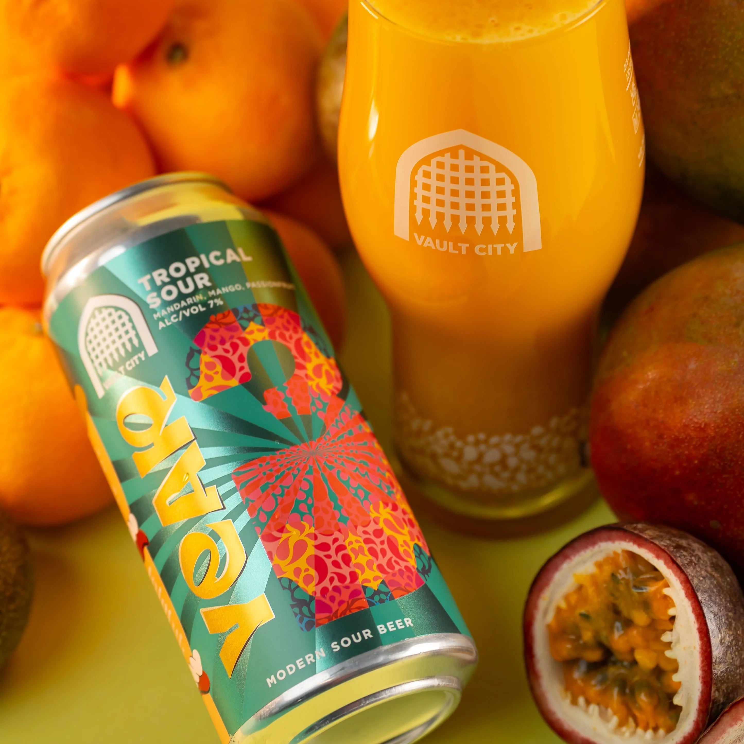 Vault City Tropical Sour can beside a poured glass with oranges, mango and passion fruit, Brewser craft beer subscription
